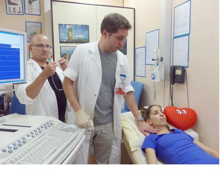 Doctors performing an ultrasound examination on a participant at Vienna General Hospital